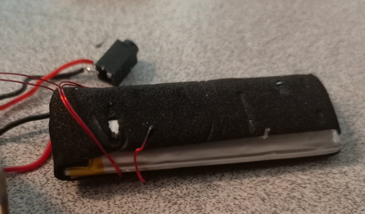 The battery has a little thermistor looking thing looping around it, presumably to prevent overcharging