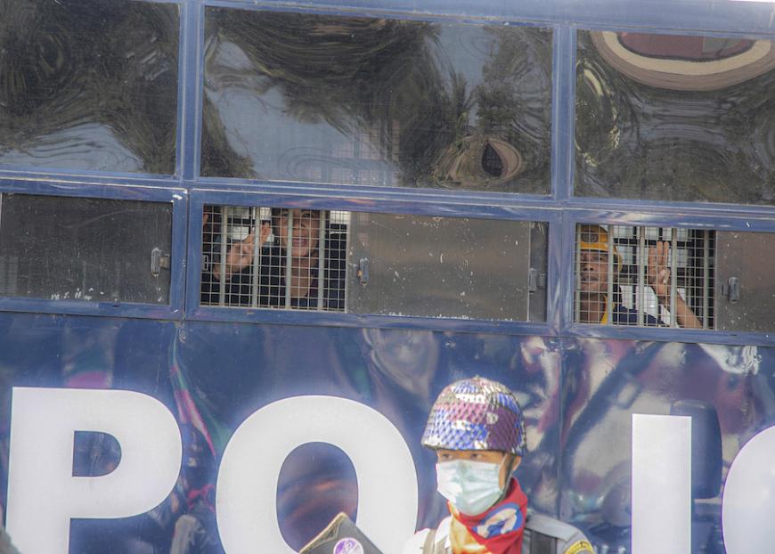 That's defiance: Myanmar activists giving the three-finger salute (against the coup) even while detained inside a police vehicle. hrw.org/news/2021/02/1…