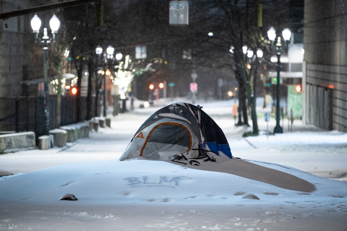 MathieuLRolland's tweet photo. A tent sits in the snow where the famous Portland elk statue once stood on SW Main St. The current winter storm has created untenable conditions for the houseless residents of Portland bringing in up to 14 inches of snow and ice throughout the metro region. Photo taken 02-12-21 https://t.co/rgZCc9nHny