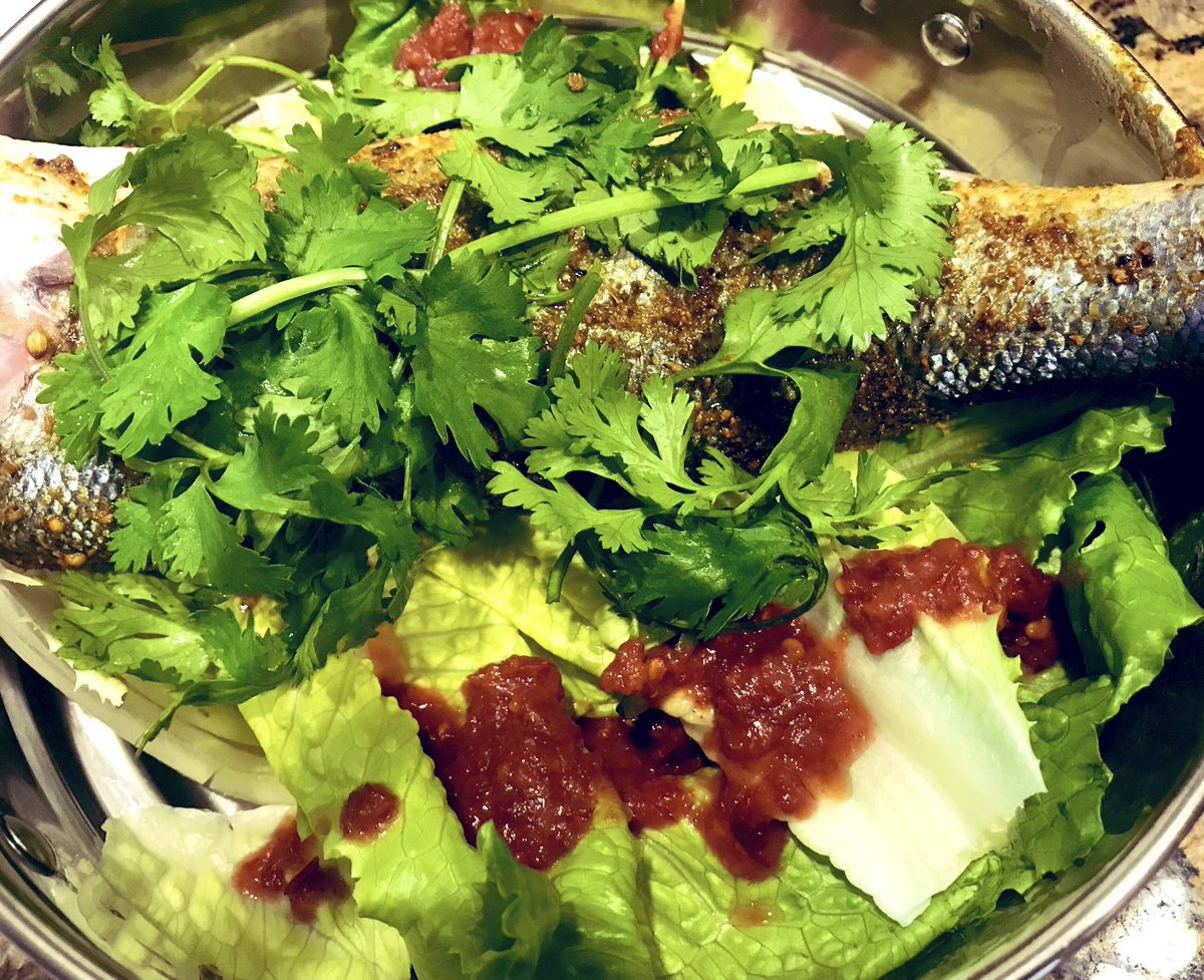 Line the basket with lettuce, cabbage, or my favorite, bok choy. Add in aromatic herbs, coarse salt, and spices. Put the fish on top- preferably a whole fish to which you've cut a slits into the skin on both sides (or fish fillets). This is what branzino looks like going in.