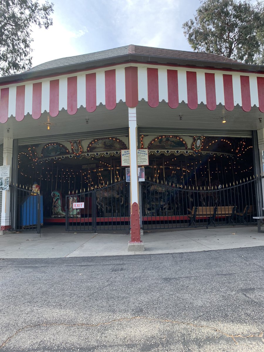It was the Merry Go Round! We wanted a look, even at it all muffled up. But then — it turned out that one of the panels was open — we could see inside. And then, as we approached, another cranked up