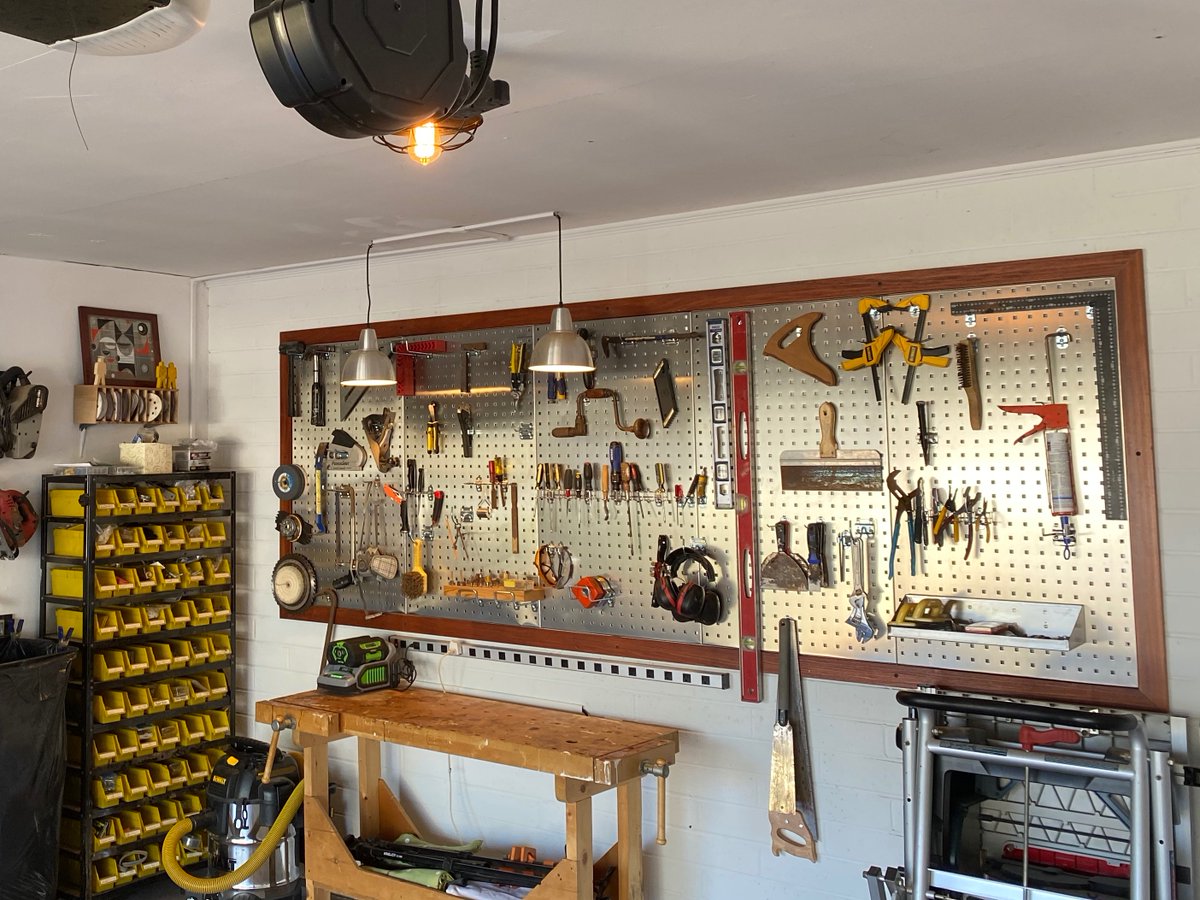 This metal board on the south wall is my favorite thing in the garage. It is called Locboard, available from Amazon. It's not cheap, but it's crazy strong and so much more beautiful than typical pegboard. I understand it's even used in surgical clean rooms.