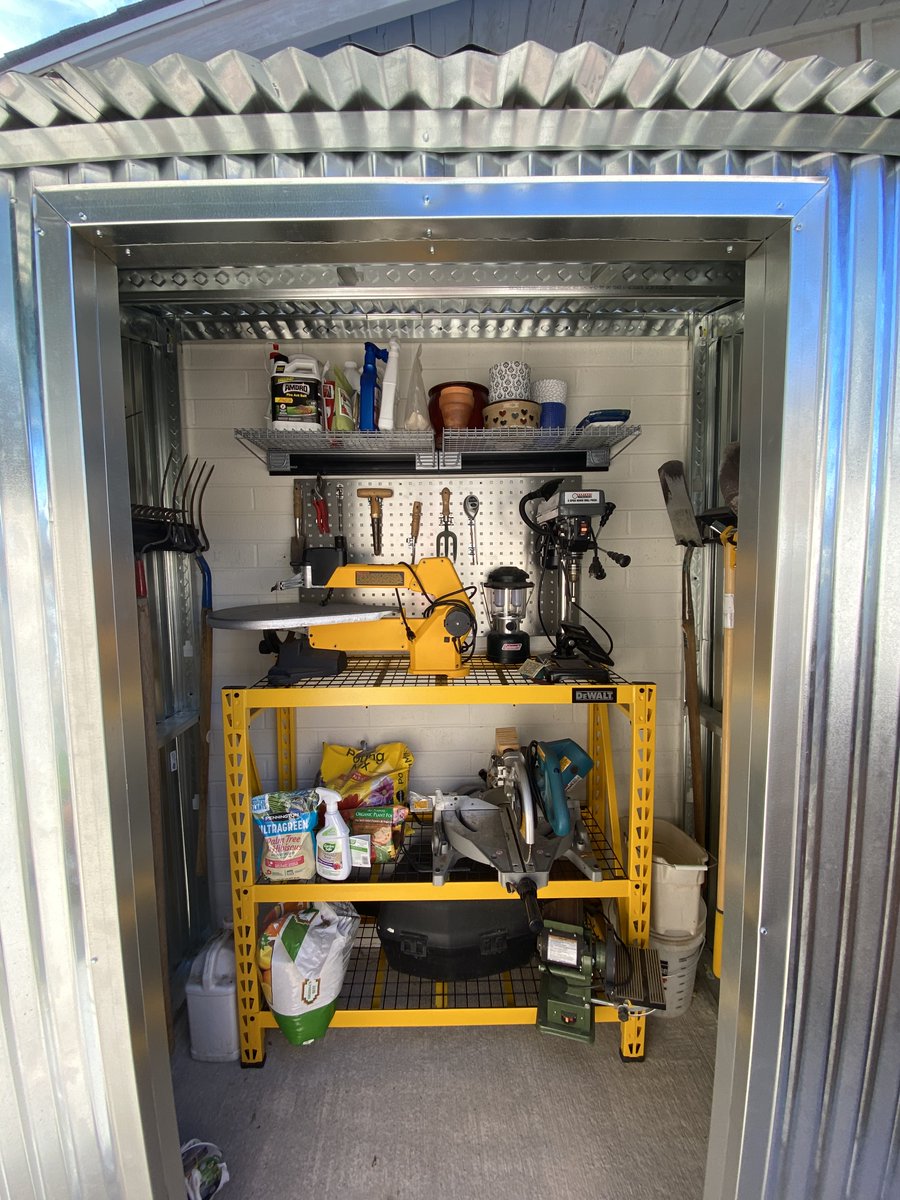 Here's the inside of the shed. More Locboard, heavy-duty DeWalt shelves. We keep woodworking tools and gardening stuff here. I just carry whatever benchtop tool I need out to a portable workbench I set up on the lawn or in the driveway when I need it.