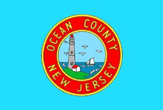 OCEAN COUNTY: Are NJ counties addicted to using cartoonish fake seals to ruin their own flags? Yes. The green is for grass, gold for sand, navy blue for sea, blue for sky. Supposed to look like your perspective looking at the ocean but it kinda looks like a hard seltzer brand