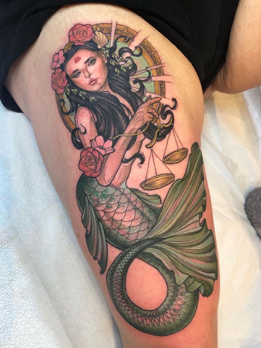 Micro-realistic style mermaid tattoo located on the