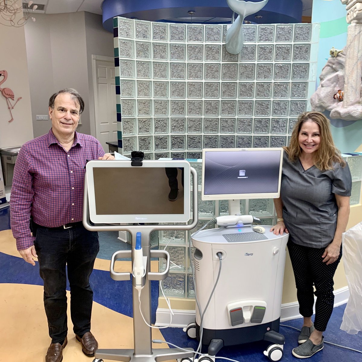 Freedman_Haas's tweet photo. Dr. Freedman and Dr. Haas are standing beside the latest Invisalign iTero digital scanner. 🎉It can scan for Invisalign in 5-10 minutes and then show you how your new smile will look. 😁 Call (561) 795-2734 to set up an appointment for your complimentary scan and consultation. 📱 https://t.co/s0Gno50rP7