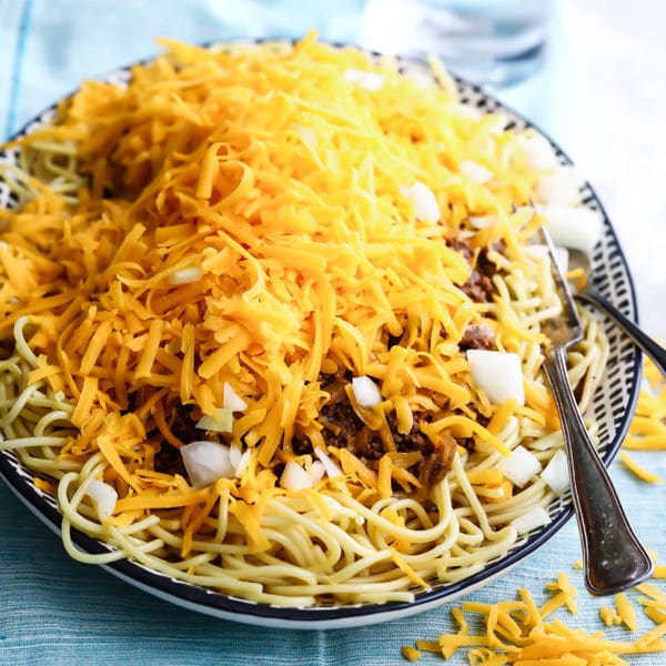 which they called "coneys" in 1922 at their hot dog stand located next to a burlesque theater called the Empress, which they named their business after. Tom Kiradjieff used the sauce to modify a traditional Greek dish, speculated to have been pastitsio, moussaka or saltsa kima