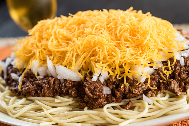 to come up with a dish he called chili spaghetti. He first developed a recipe calling for the spaghetti to be cooked in the chili but changed his method in response to customer requests and began serving the sauce as a topping,