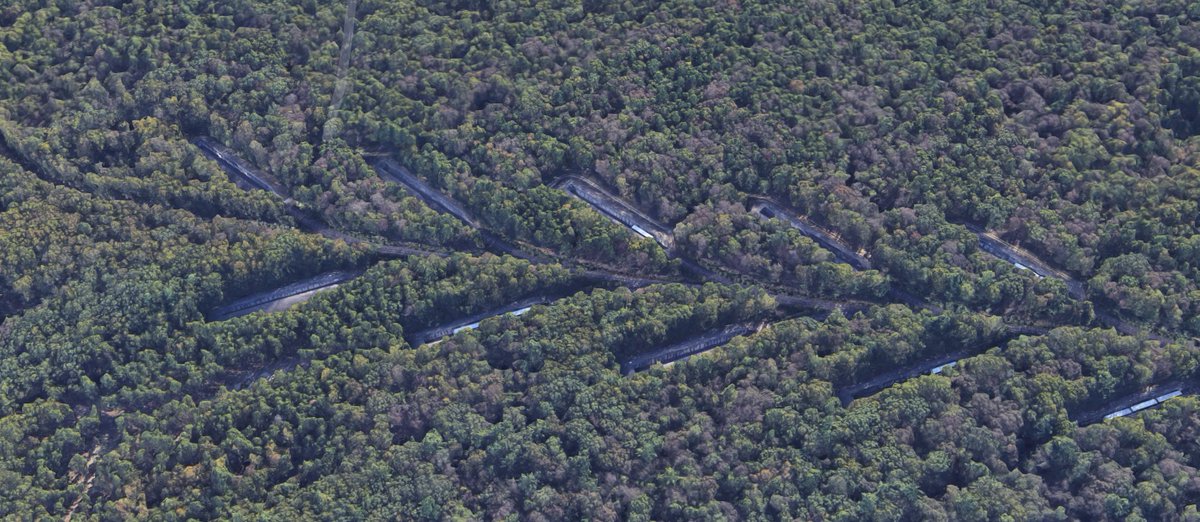 These leaf-like sidings look odd from the air, and notably are located far away from the rest of the site. Why? Well, it's to store excess munitions before they can be properly stored in bunkers or warehouse facilities. Zoom in and you'll find something special about them...