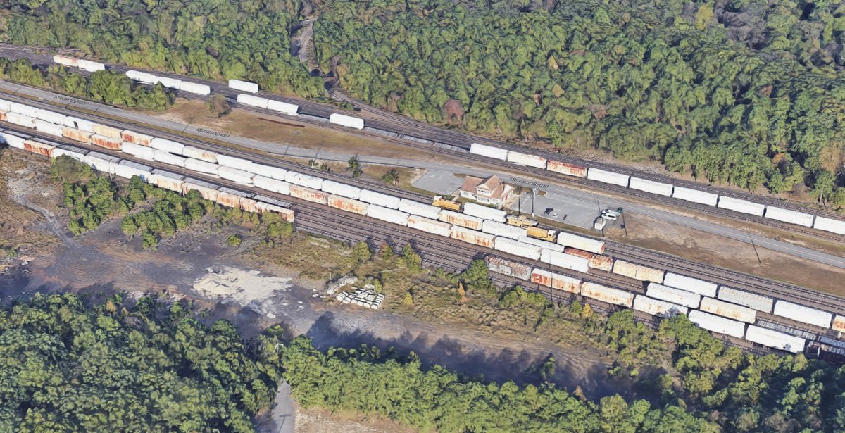 There's also a small yard with a whole bunch of these white (and some rusty) boxcars, as well as the switchers which are captive and serve just to make shuttle runs to the pier and back to the facility.