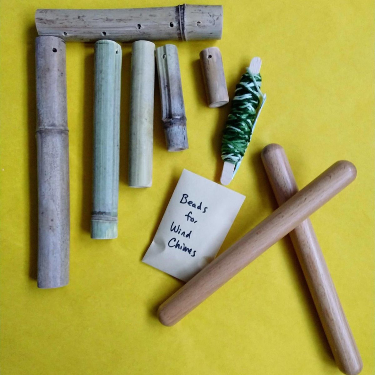 OVMODTweets's tweet photo. [Image description: 3. yellow background with supplies for making wooden wind chimes, including bamboo, envelope labeled beads, and wooden rhythm sticks.] https://t.co/acdm8IvAL3