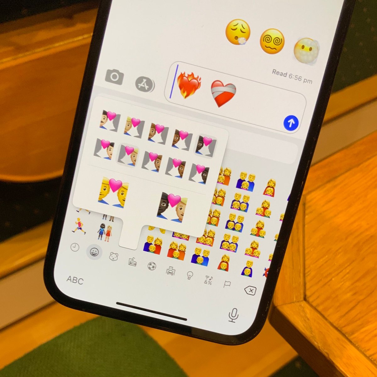 Emoji keyboard showing a user interface to choose a different skin tone for each person in a couple