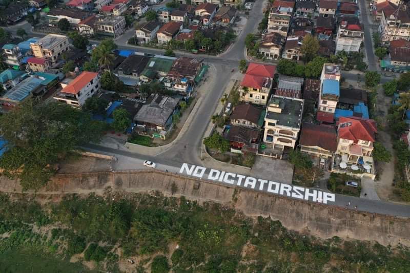 88rimmeram's tweet photo. @RapporteurUn Image from today “No Dictatorship” painted on a road in #Myanmar  Myitkyina, Kachin State, joining the nationwide opposition against the military regime on Thursday.
GIVE BACK HUMAN RIGHTS
#Feb18Coup 
#WhatsHappeningInMyanmar https://t.co/jzR1C38CG5