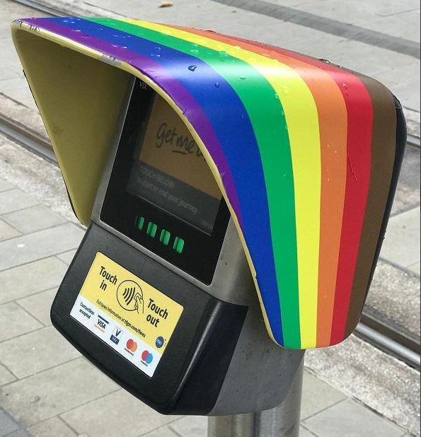 [3/8] Stepping up the game, in comes  @MCRMetrolink with this contactless scanner. This eight colour flag is known as the Philadelphia Flag, created in 2017 to give representation to Black people and people of colour. @MCRMetrolink