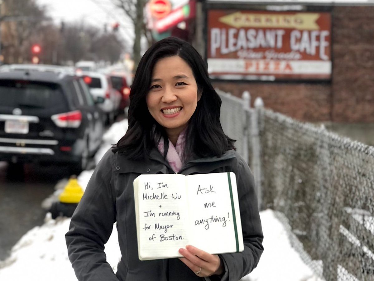 Photo of Michelle Wu holding a notebook with the handwritten text, "Hi...