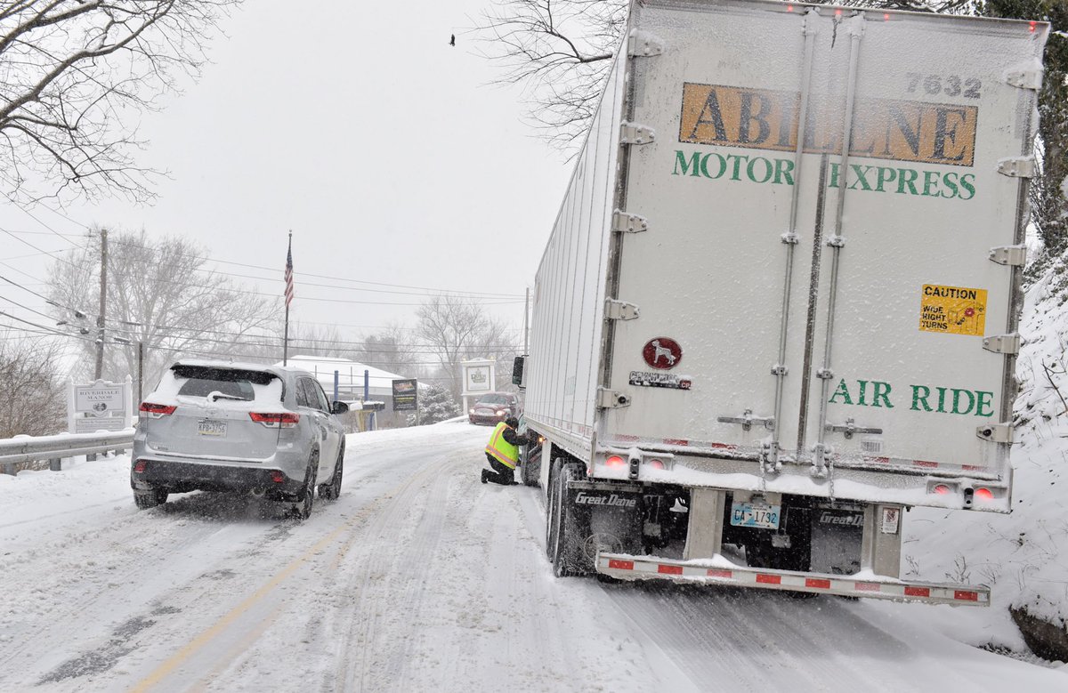 SuzetteLNP's tweet photo. Alexander Perez of Chesterville, VA, works to put chains on his rig as he was unable to get up a hill on Pitney Road in East Lampeter Township due to an unloaded trailer. #lancastersnow @LancasterOnline 2021snow https://t.co/Zm2qbquI2B