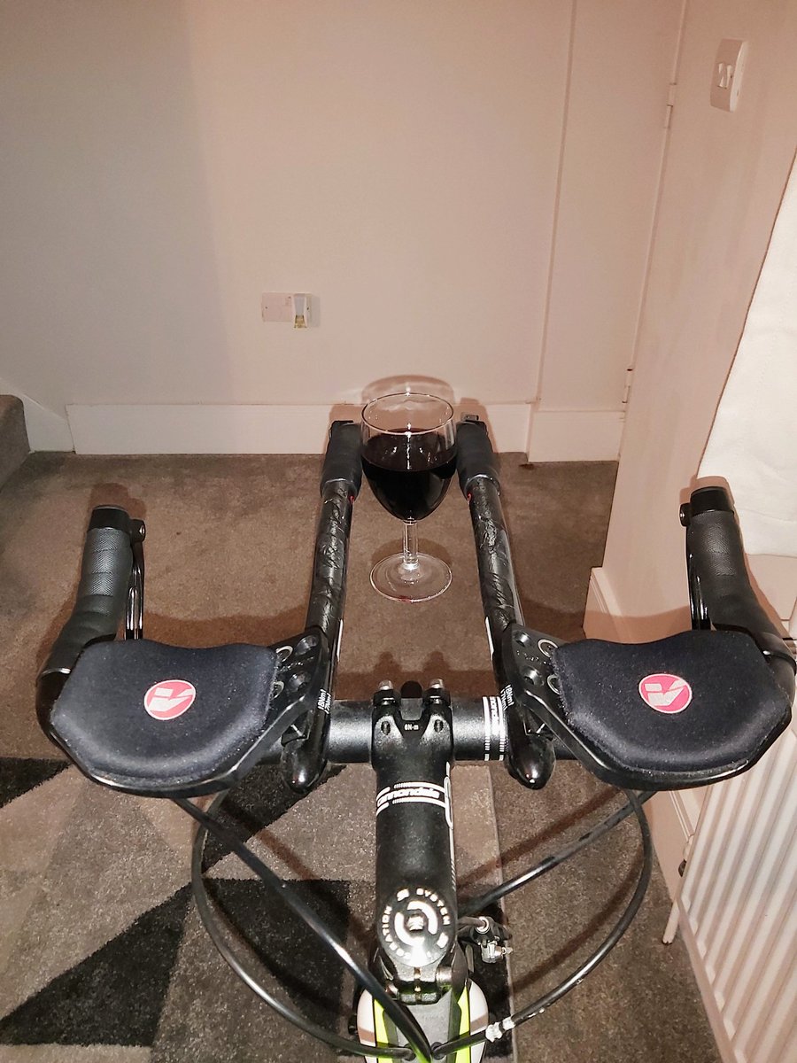 IainMcCracken4's tweet photo. Tri bars = Laptop stand first, now wine glass holder 🤣 This cycling malarkey is much easier when you can't feel your legs 😅🤪 #notadvised #BRIT2021Challenge https://t.co/OWx8Ll22ME