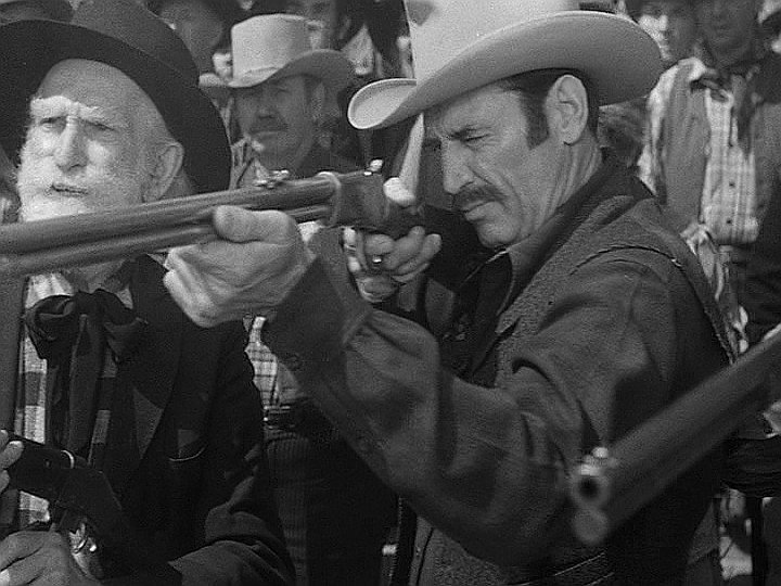 Of course, the Henry wasn't as widely available in the 20th century as the Winchester 92 so filmmakers started modifying the 92 by removing the handguard. This guy in Winchester 73 has a 92. "No one will know! It's not like the whole movie centers around new rifle technology!"