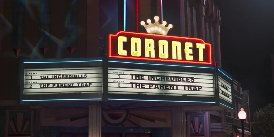 The Coronet Theatre is playing The Incredibles (2004) and The Parent Trap (1998) The former about a superhero family in the suburbs and the latter about reunited twins. The Parent Trap title also works as a double entendre since Vision is literally trapped in Westview.