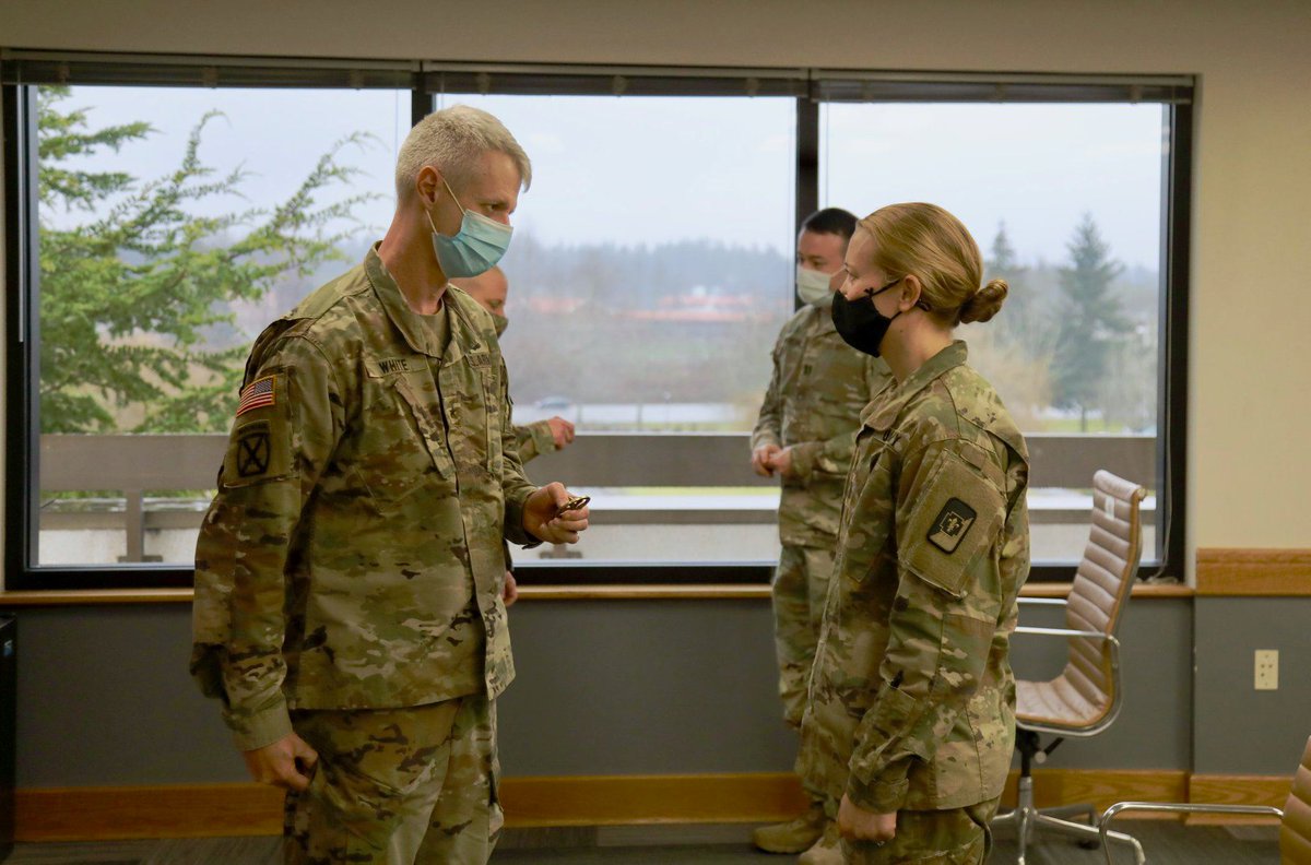 I_Corps's tweet photo. Officers in the 47th Combat Support Hospital's Critical Care Team were honored for saving the life of a passenger during a flight.  On a trip to Guam for #TaskForceWest's COVID-19 Relief Mission, a fellow traveler fell unconscious and that's when they sprang into action. #ICorps https://t.co/aOoK4n8fbw