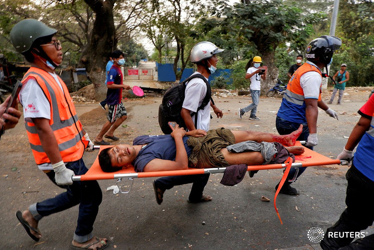 Medics rush away a wounded man after shooting by Myanmar forces at protest in Mandalay. At least two people were killed. #WhatsHappeningInMyanmar