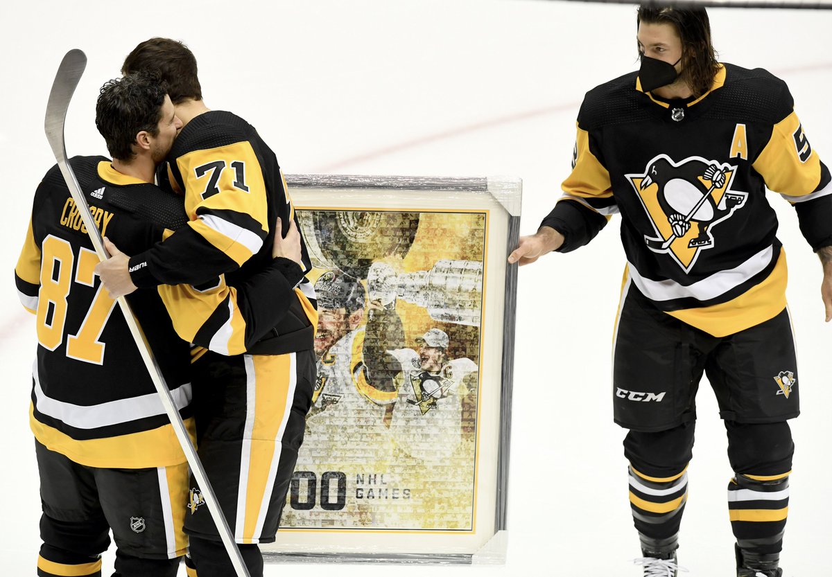 .Penguins Evgeni Malkin hugs Sidney Crosby as Kris Letang looks after givin...