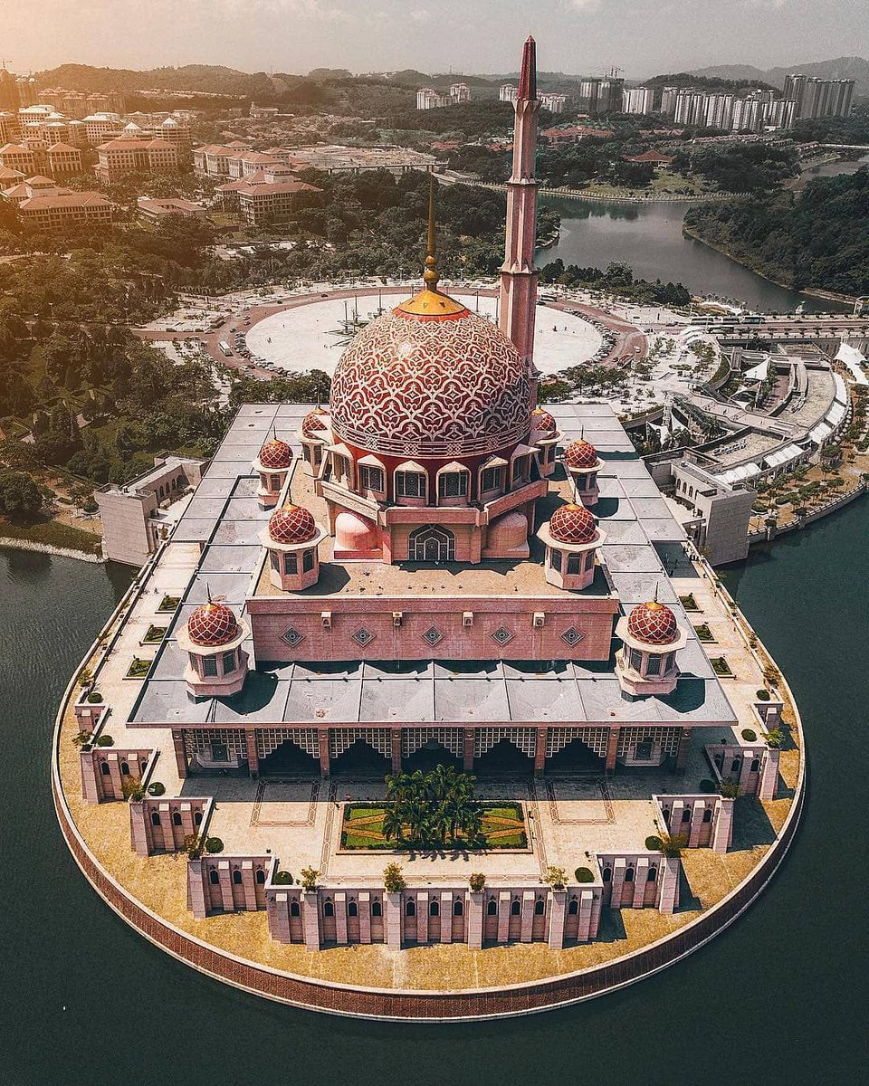 We're visiting the Masjid Putra (Malay for Putra Mosque) in Putrajaya, Malaysia. Its construction was completed in 1999. It's located on the man-made Putrajaya Lake and also next to the building that is the office complex of the Prime Minister of Malaysia,.....