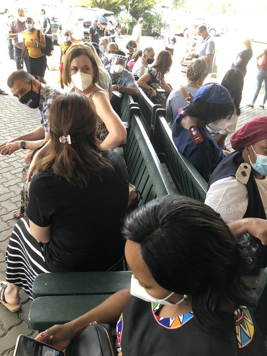 DrStevenZA's tweet photo. Doctors waiting to get the Johnsons vaccine. This is the crowd outside the hospital. Not even past the front door. Social distancing? This exercise is going to kill sone if us! https://t.co/AZ7fYbH6Tp