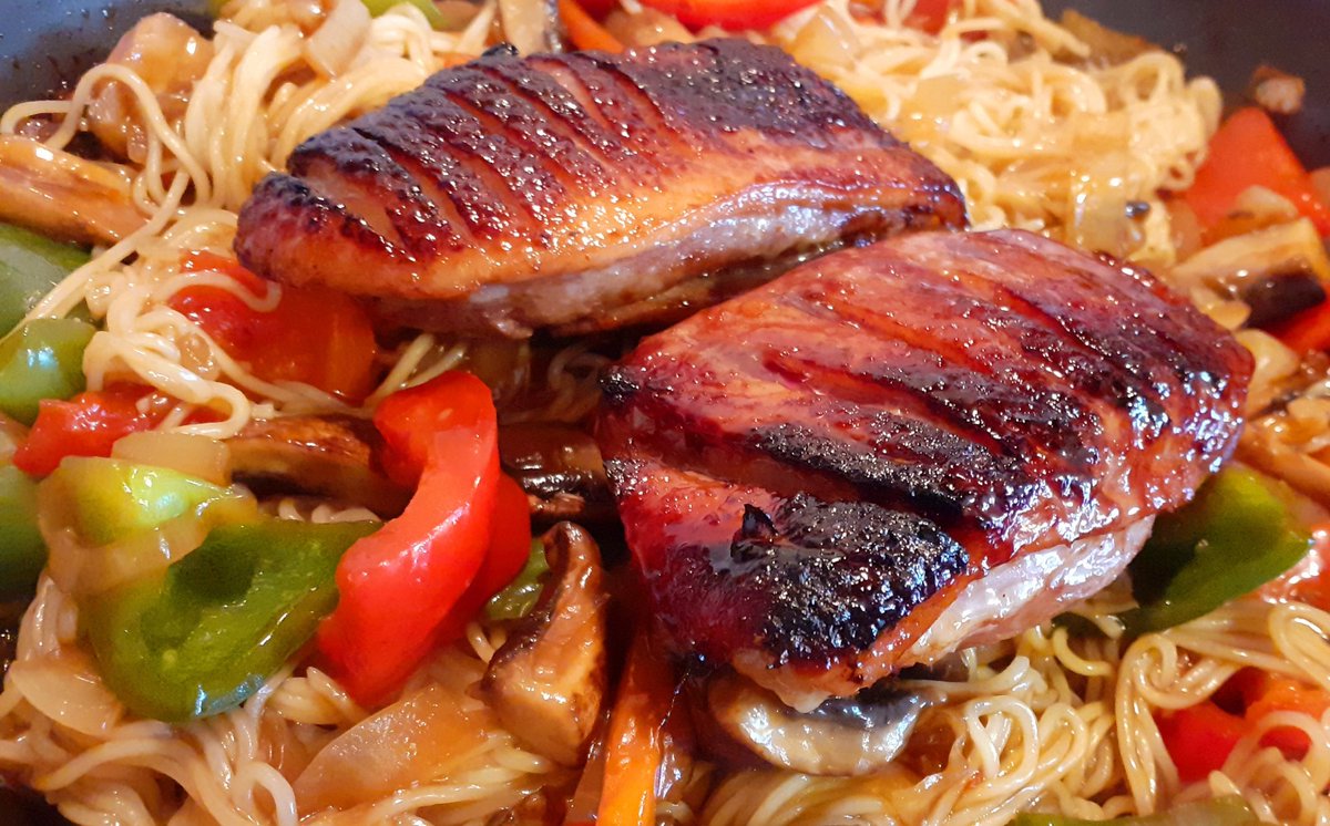 Crispy duck breast with stir fry vegetables noodles