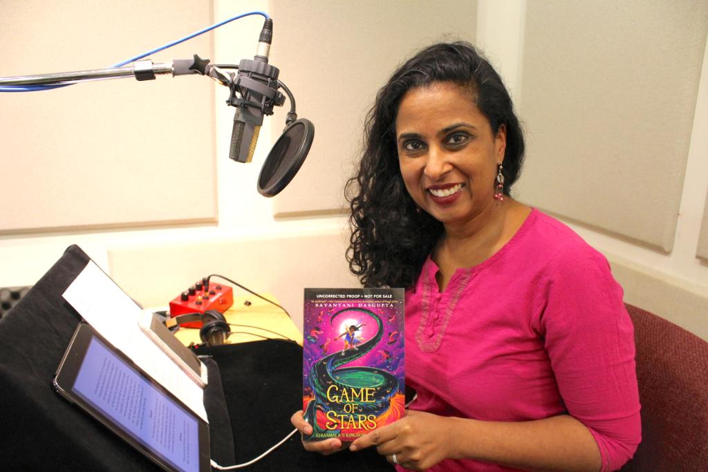 Scholastic's tweet photo. Not only did author Sayantani DasGupta write #TheSerpentsSecret and its sequel #GameOfStars; she also recorded the audiobook editions! Check out this behind-the-scenes photo of @Sayantani16 in the studio and listen to an excerpt of the audiobook here: https://t.co/7ngh8dTnNm https://t.co/uuvNwoCzaY