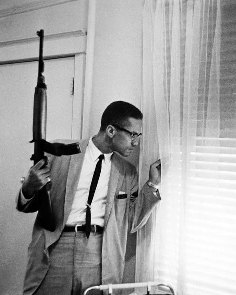 BIG MALCOLM X PLAY COUSIN on Twitter: "Malcolm's death threats were the  cause behind the iconic Don Hogan Charles photo of Malcolm with his M1  Carbine peeking out the window. He had