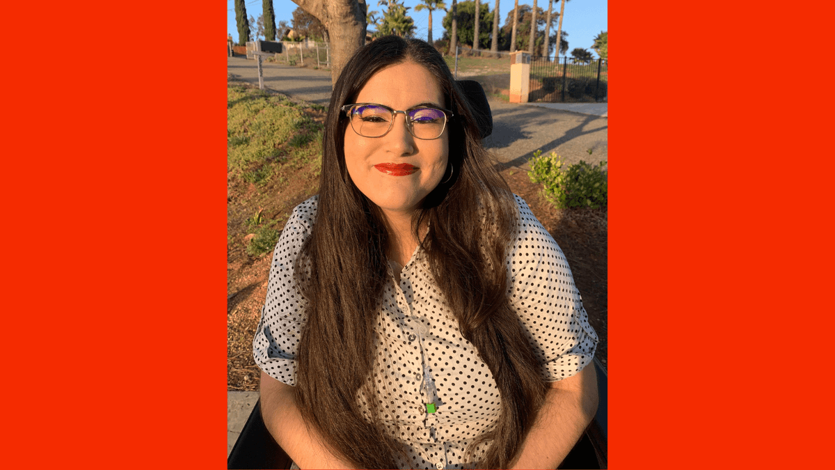 Graphic with a red background with a photo of Alena Morales, a Mexican Filipina woman, sitting in her wheelchair among San Diego palm trees. Her long brown hair is styled down around her shoulders, and she dons red lipstick with winged eyeliner. She is wearing a white button up shirt with black polka dots, and her central line hangs out from the neckline of her shirt.