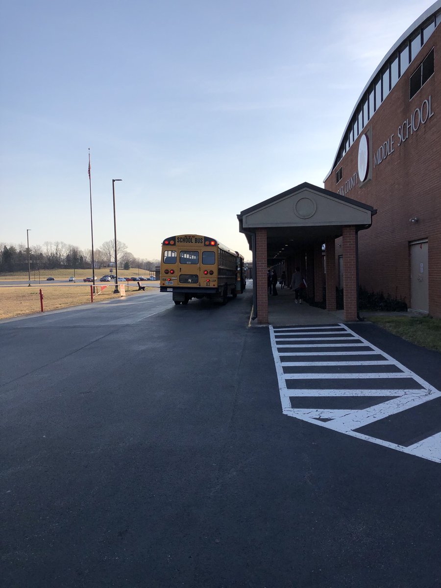 PaulSPoole's tweet photo. Buses, parent drivers, and a large welcoming Hornet at HCMS! Welcome back middle school students and families! #TeamHancock https://t.co/vhKM5vstEg