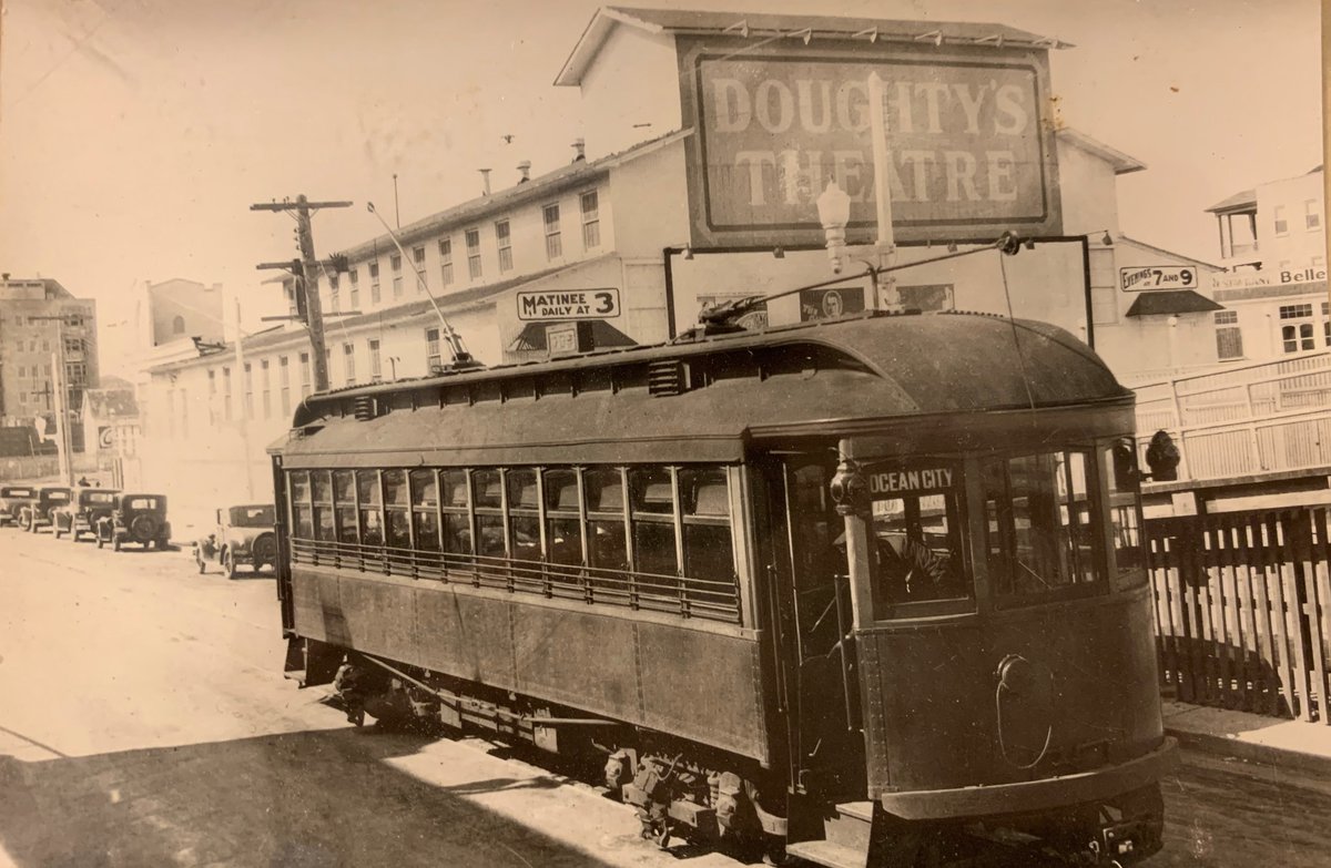 OCNJHM's tweet photo. The Shore Fast Line carried passengers between Ocean City and Atlantic City from 1907 to 1948. The trolley cars stopped at 8th and the Boardwalk right next to Doughty's Theater, which became the Village Theater in 1933. https://t.co/lRKHiGGPMH