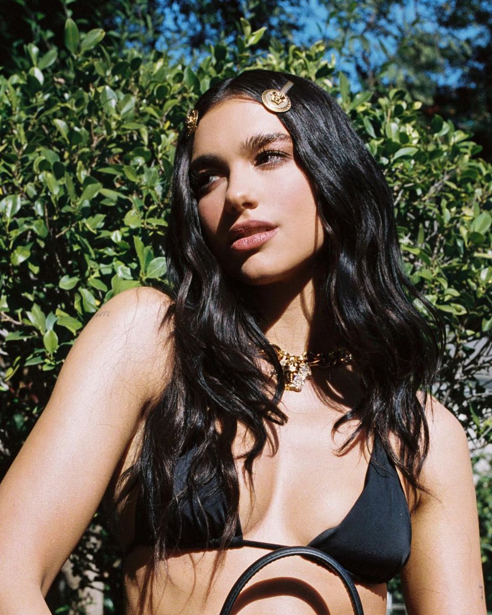 Versace's tweet photo. A very Versace girl - #DuaLipa showcases her new #VersaceLaMedusa bag.

#VersaceCelebrities https://t.co/jiPe7z0M5g
