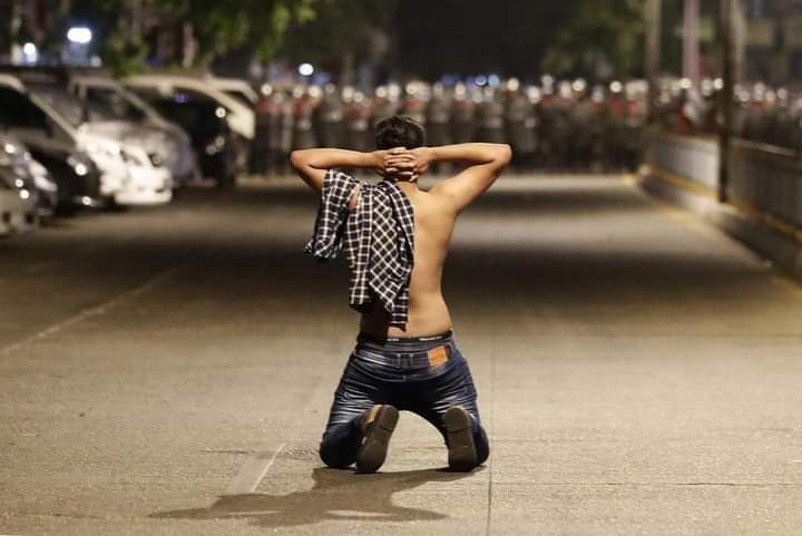 A demonstrator kneeled as he protest against the military coup while riot police advance on a street as tensions rise in Tarmwe Township, Yangon on 25 Feb 2021. <a href="/RapporteurUn/">UN Special Rapporteur Tom Andrews</a> <a href="/UN_HRC/">UN Human Rights Council</a> <a href="/KenRoth/">Kenneth Roth</a> <a href="/Reuters/">Reuters</a> 
#Feb25Coup
#WhatsHappeningInMyanmar