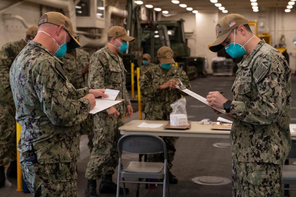 USNavy's tweet photo. Protecting the fleet; Protecting each other #SinkCOVID 💉 ⚓ 

#USNavy Medicine Readiness &amp; Training Unit Bahrain administers the COVID-19 vaccine to personnel from the amphibious transport dock ship USS San Diego (LPD 22) in Manama, Bahrain, Feb 26.  @US5thFleet #NavyReadiness https://t.co/0fd7Sxct8b