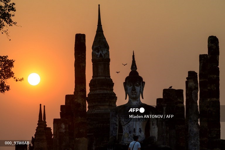 AFP Photo (@afpphoto) on Twitter photo #Thailand - A tourist looks at the Buddha statue at Wat Mahathat during sunset in the Sukhotai Historical Park.A picture by #AFP photographer <a href="/AFPMladen/">Mladen Antonov</a> #Thailand - A tourist looks at the Buddha statue at Wat Mahathat during sunset in the Sukhotai Historical Park.A picture by #AFP photographer <a href="/AFPMladen/">Mladen Antonov</a>