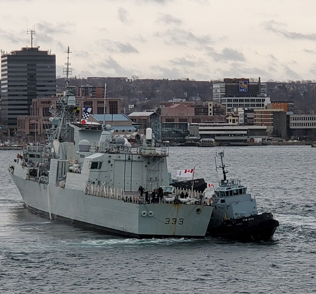 Tugs and #HMCSToronto fighting the wind this morning.