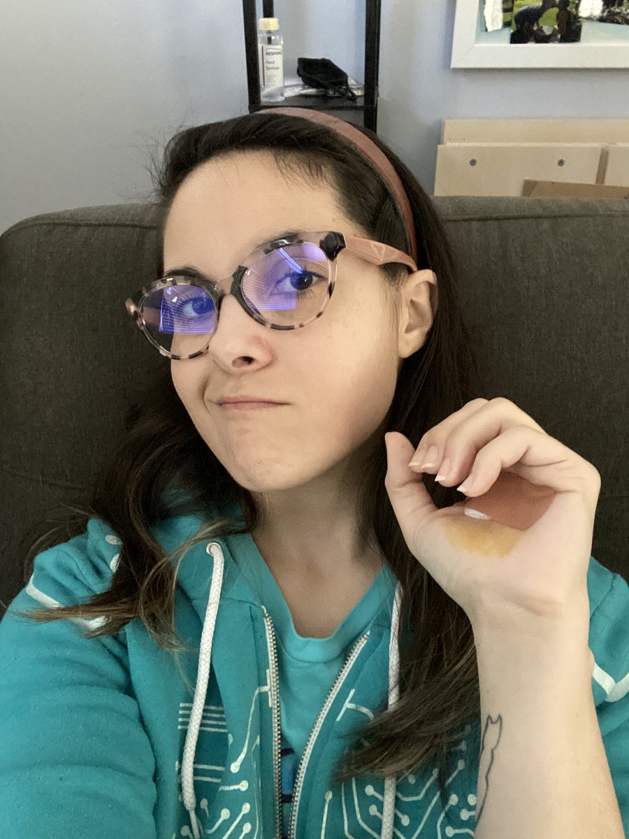 Kristy with a pouty face showing off her dressing for her minor stab wound in her left hand