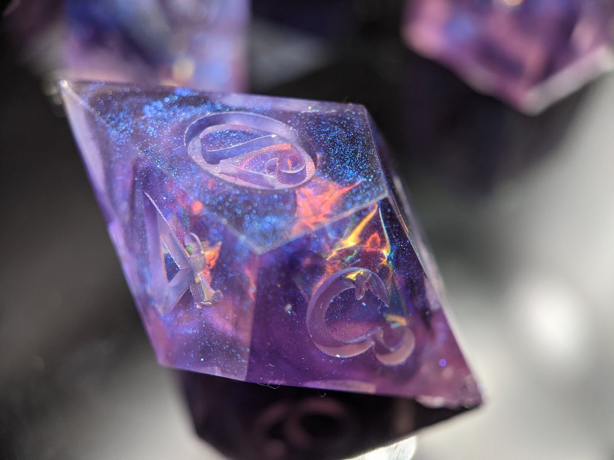 An old style: Her Empress of the Stars

Purple and pink sparkly opal dice.