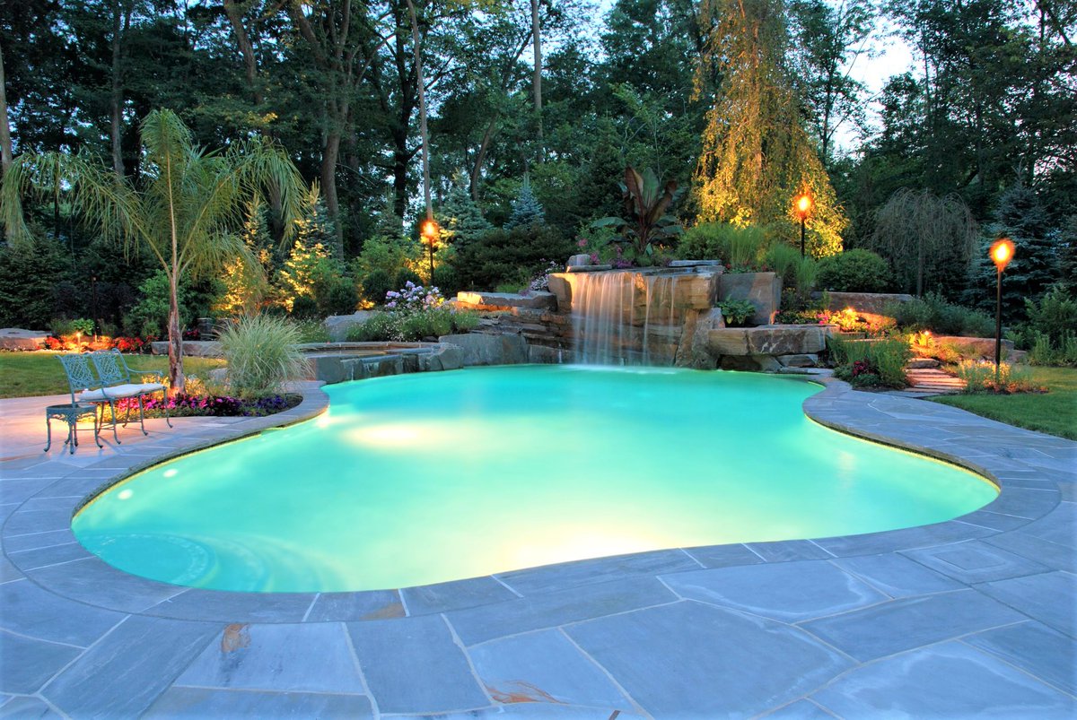 This 20 ton boulder was craned into place and was the focal point of this tropical themed backyard in #Allendale #NJ ! #beforeandafter #bettercallcip! 201-785-0800 #staycation #luxurypool #waterfalls #summer2021 #poolconstruction #poolbuilder #wedoitall #swimmingpoolconstruction
