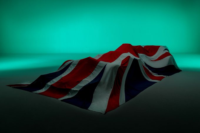 The AMR21 hidden under a Union Flag.