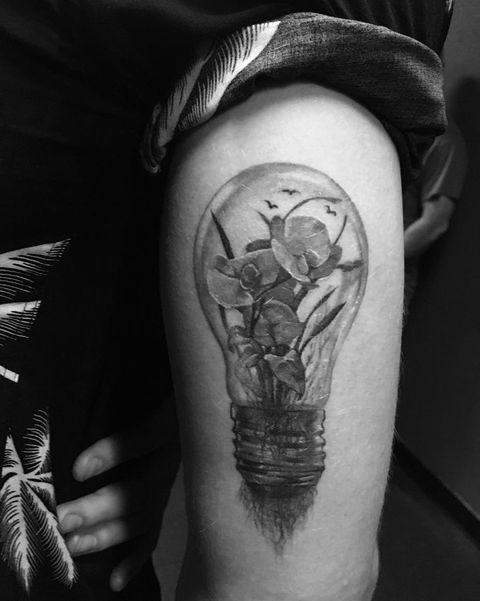 light bulb - representing his sophomore album ‘illuminate’ and blue orchids, his mom’s favorite flower