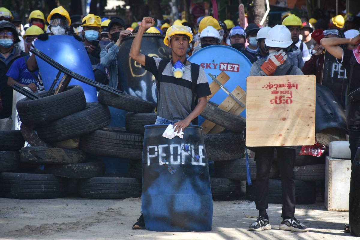 Some 1,000 young protesters are fighting a war of attrition with police in Yangon's Sanchaung Township this morning. Police move in, brake down barricades with an end loader, then retreat; protesters return, rebuild and repeat, says our photojournalist. #WhatsHappeningInMyanmar