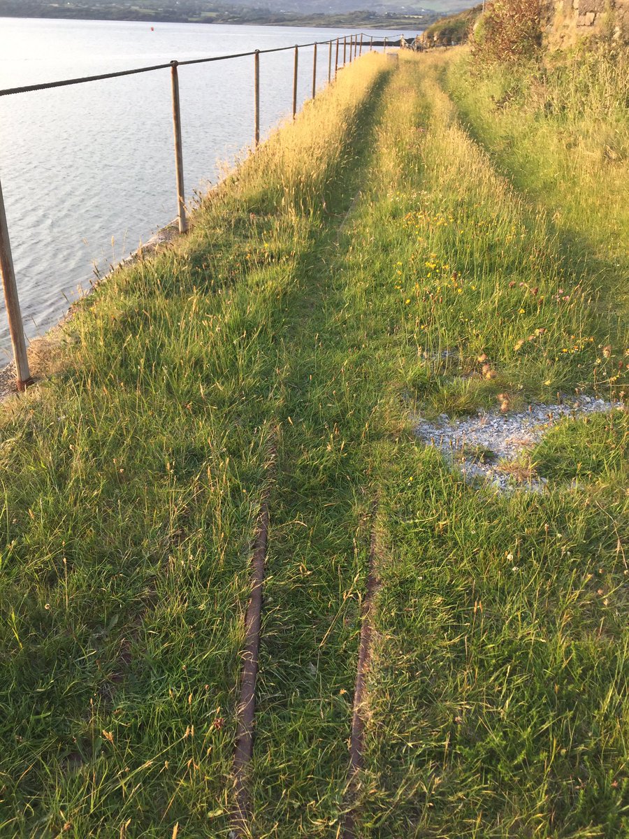 helenriddell's tweet image. Railway tracks on an island. Former British Admiralty engineers’ workshop built in early 1900s and later used as a base for Glenans Sailing School. A narrow gauge railway linked it to a nearby pier, remains of a turntable are also still there #BereIsland #EngineersWeek2021
