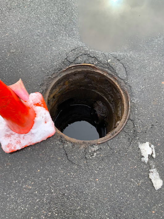 ALLOUTSealcoat's tweet photo. This Staten Island maintenance hole cover was damaged during the recent winter storm, creating a parking lot liability needing immediate attention. Rest assured knowing that when a safety issue arises, ALL OUT is available to respond 24/7. https://t.co/LDbSPvbeP6