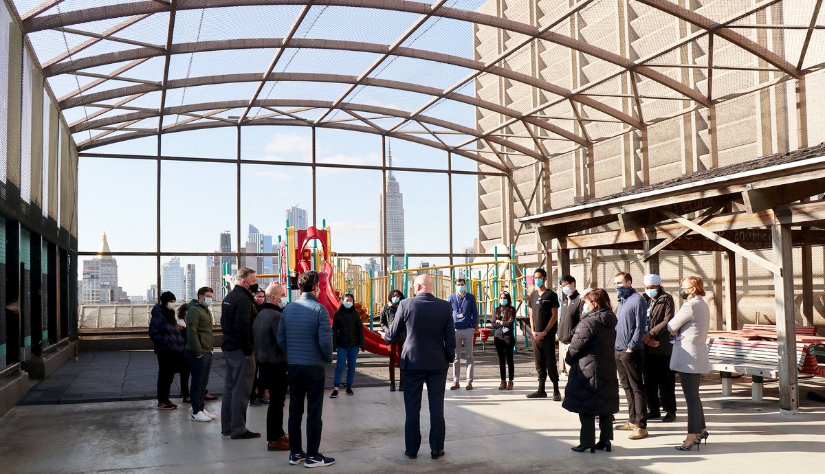 Docs wearing sunglasses w/ the image of the Chf of Medicine gathered on our rooftop to mark #NationalHospitalistDay. Thanks to our #Hospitalists, whose specialty is caring for patients admitted to the hospital, after a hard year of caring for #COVID19 patients. #HowWeHospitalist