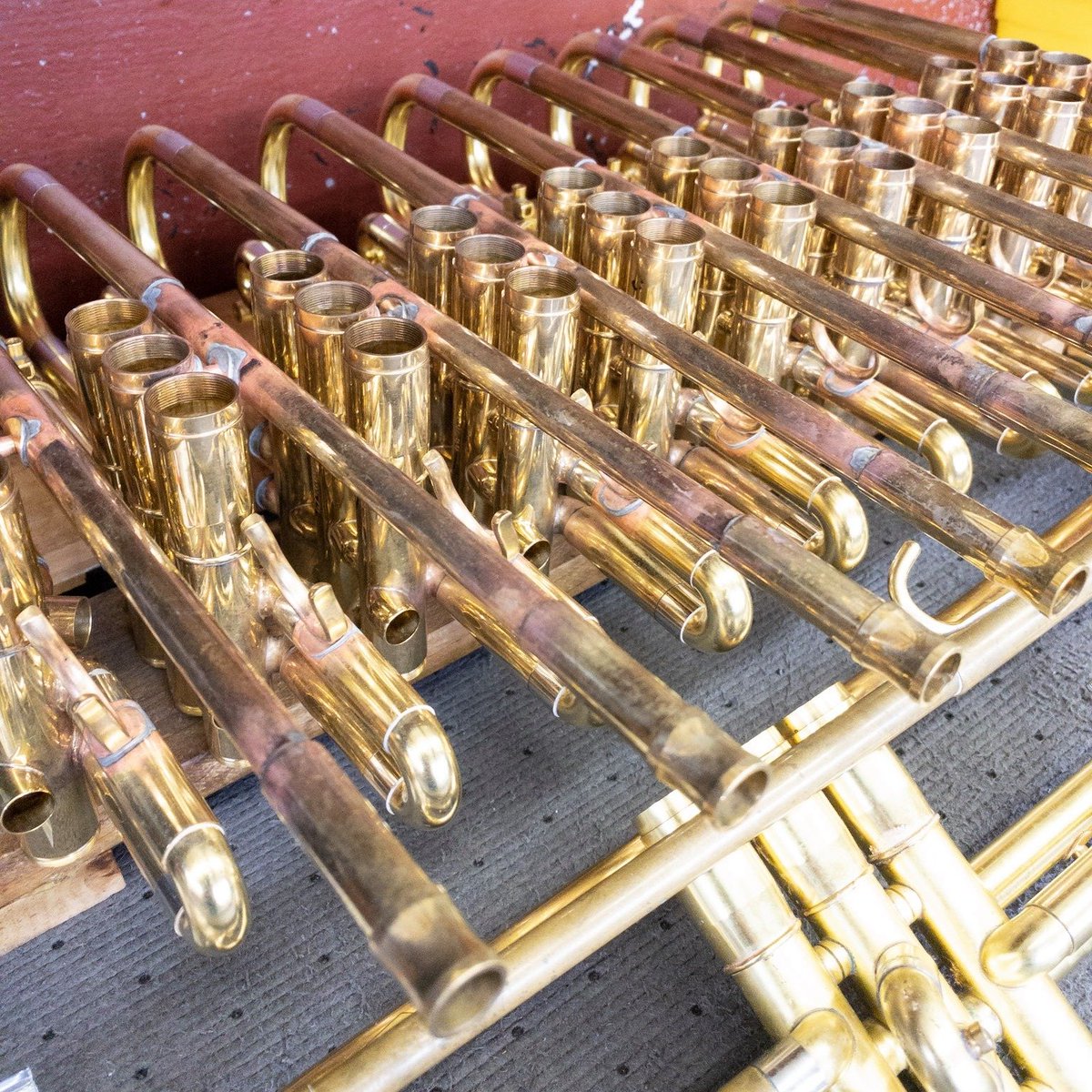 A rack of trumpets making their way through production.