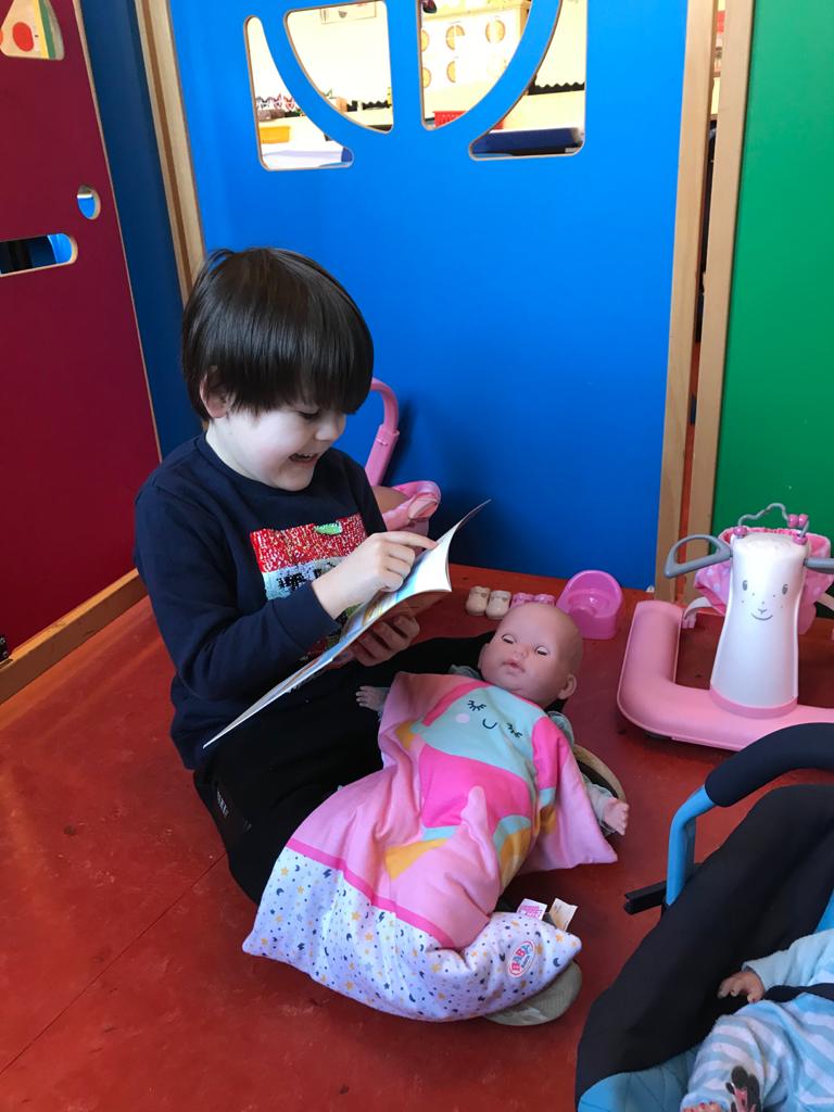 This Primary 1 enjoys reading to baby Elsa to help her fall asleep. He is doing really well using his finger to point to the words!